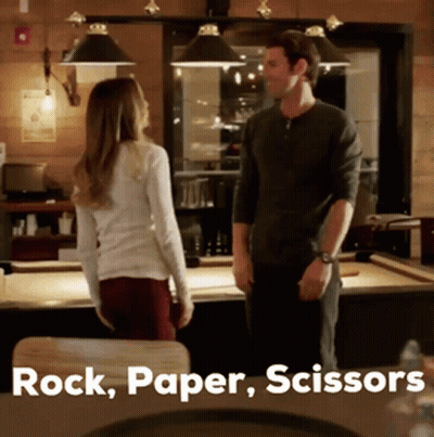 Man And Woman At Pool Table Saying Rock Paper Scissors GIF