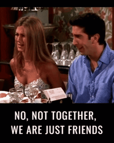 Man And Woman At Table Saying No Not Together We Are Just Friends GIF