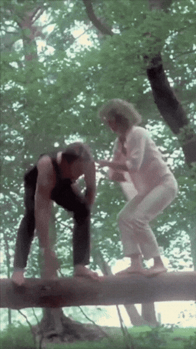 Man And Woman Balancing On A Log GIF