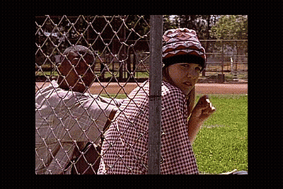 Man And Woman Behind Chain Link Fence In Park GIF