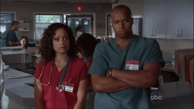 Man And Woman Crossed Arms With ABC Badge GIF