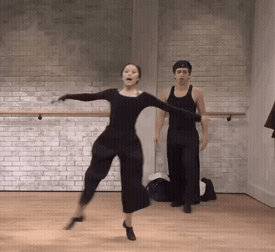 Man And Woman Dancing Against Brick Wall GIF