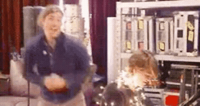 Man And Woman Dancing Among Electronics GIF
