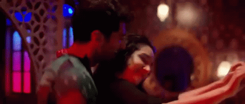 Man And Woman Dancing In Dark Room In Front Of Mirror GIF