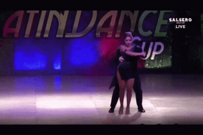 Man And Woman Dancing In Front Of Attendance Sign GIF