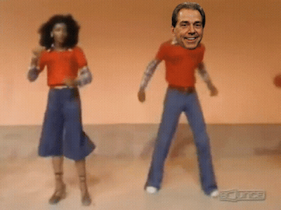 Man And Woman Dancing In Front Of BC Juice Sign GIF