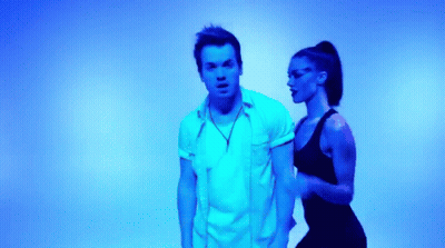 Man And Woman Dancing In Front Of Blue Light GIF