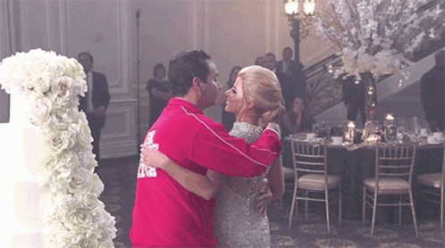 Man and Woman Dancing in Front of Cake