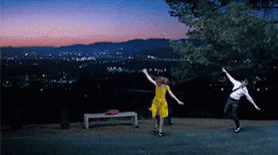 Man And Woman Dancing In Front Of City At Night GIF