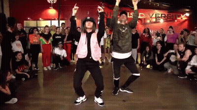Man And Woman Dancing In Front Of Crowd GIF