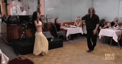 Man And Woman Dancing In Front Of Crowd GIF