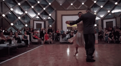 Man And Woman Dancing In Front Of Crowd GIF