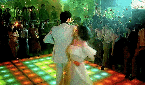Man And Woman Dancing In Front Of Crowd GIF