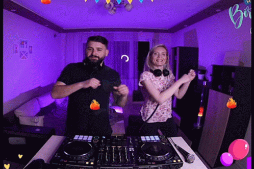 Man and Woman Dancing in Front of DJ Set