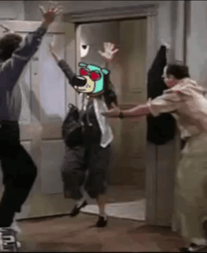 Man And Woman Dancing In Front Of Door With Picture Of Bear On Head GIF