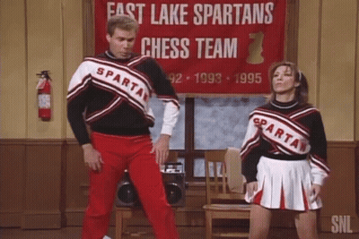 Man And Woman Dancing In Front Of Fast Lake Spartans Chess Team Sign GIF