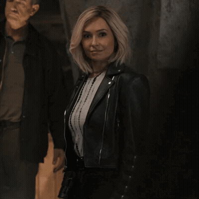 Man And Woman Dancing In Front Of Fast Lake Spartans Chess Team Sign GIF