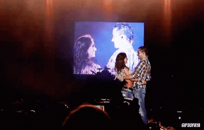 Man And Woman Dancing In Front Of GIFSOFAYA Screen GIF