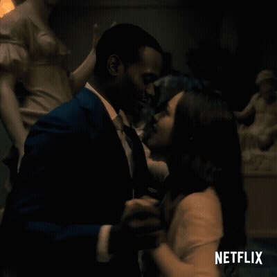 Man And Woman Dancing In Front Of Netflix Sign GIF