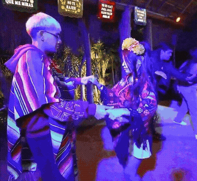 Man And Woman Dancing In Front Of No Te Rajes Sign GIF