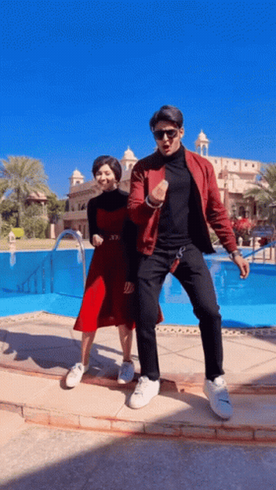 Man And Woman Dancing In Front Of Pool GIF
