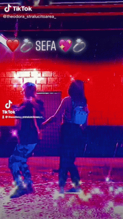 Man And Woman Dancing In Front Of Sefa Sign GIF