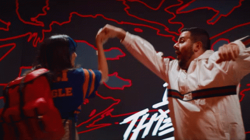 Man And Woman Dancing In Front Of Sign The GIF