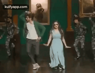 Man And Woman Dancing In Front Of Soldiers GIF