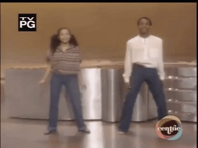 Man And Woman Dancing In Front Of TV GIF