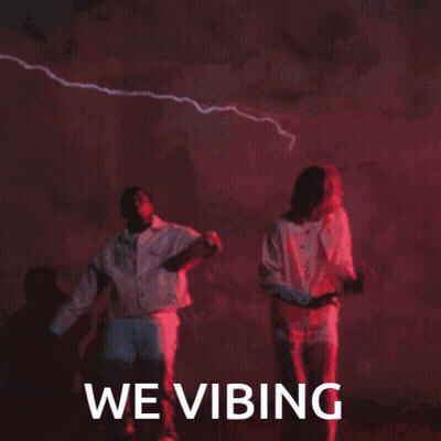 Man And Woman Dancing In Front Of We Vibing Sign GIF