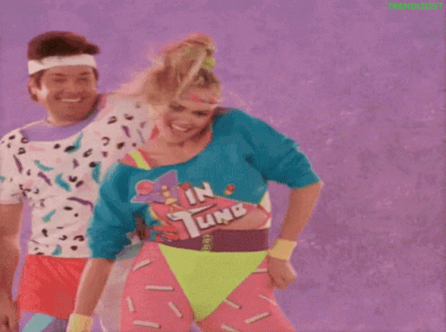 Man And Woman Dancing In Neon Clothes GIF
