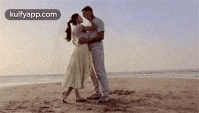 Man And Woman Dancing On Beach GIF