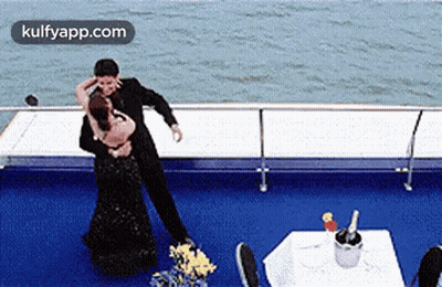 Man And Woman Dancing On Boat With Champagne GIF