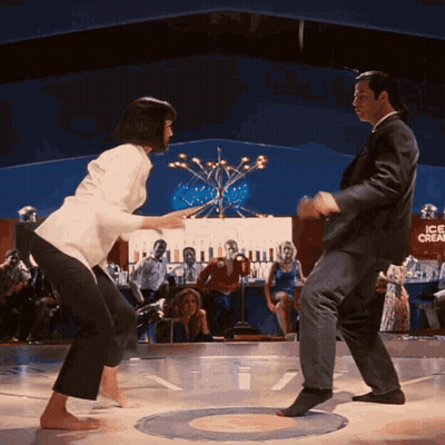 Man And Woman Dancing On Stage In Front Of Ice Cream Sign GIF