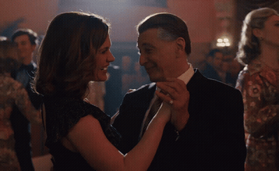 Man And Woman Dancing On Stage In Front Of Record TV Sign GIF