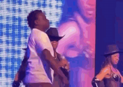 Man And Woman Dancing On Stage With Mic GIF