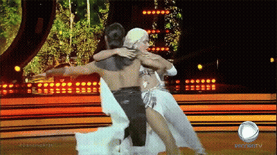 Man And Woman Dancing On Stage With Record TV Sign GIF