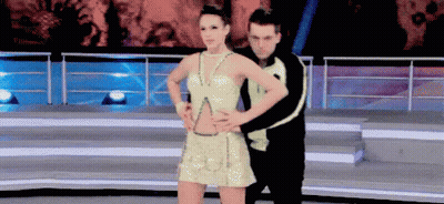 Man And Woman Dancing On Stage, Woman In Gold Dress GIF