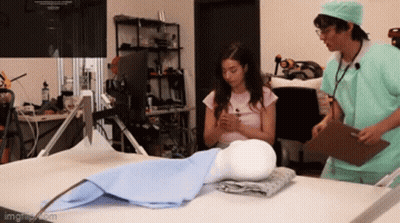 Man And Woman Doctors Looking At Mannequin GIF