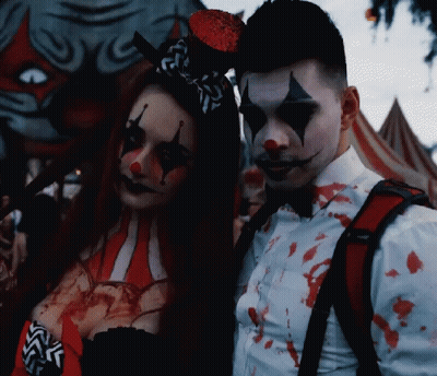 Man And Woman Dressed As Clowns GIF