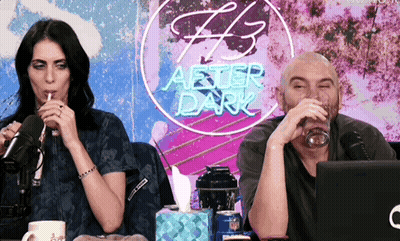Man And Woman Drinking In Front Of After Dark Sign GIF