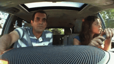 Man And Woman Driving Car, Woman Talking On Cell Phone GIF