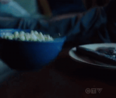 Man And Woman Eating Popcorn On Couch GIF