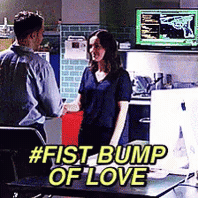 Man And Woman Fist Bump Of Love In Front Of Computer GIF
