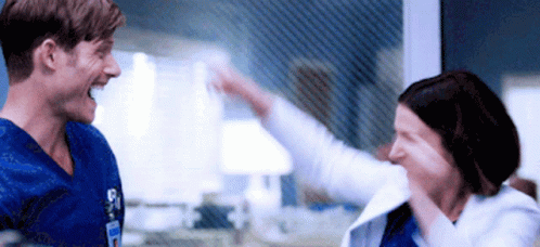 Man And Woman Giving Each Other High Five GIF