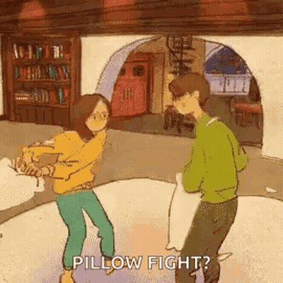 Man And Woman Having Pillow Fight GIF