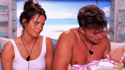 Man And Woman Holding Baby Doll Saying Love Island GIF