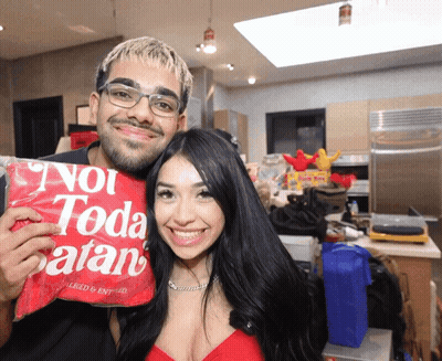 Man And Woman Holding Bag Saying Not Toda Satan GIF