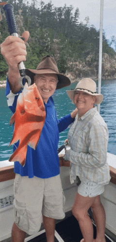 Man And Woman Holding Fish On Boat GIF
