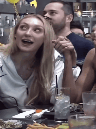 Man And Woman Holding Hands At Table GIF